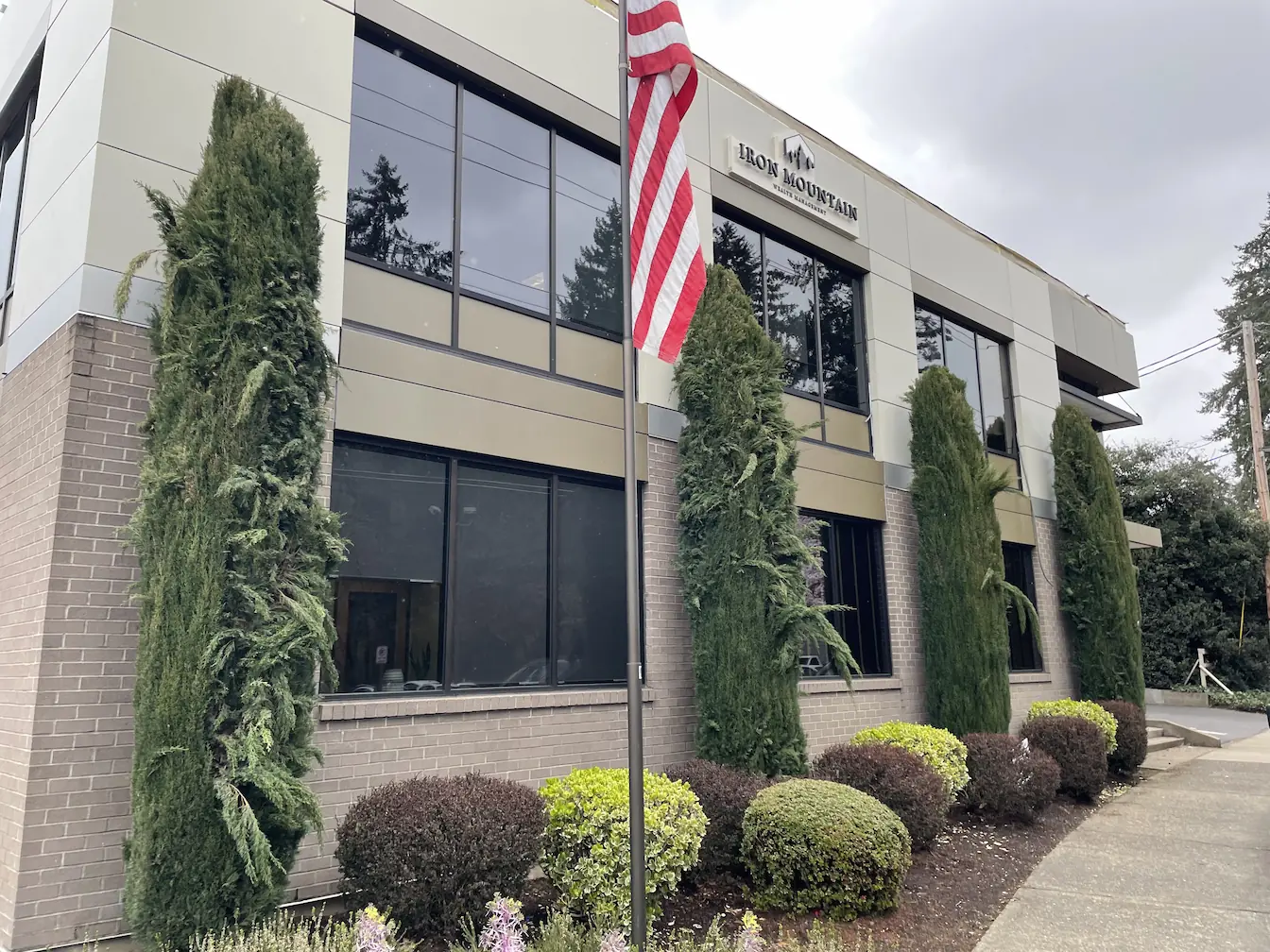 office building with large windows, tan and gray exterior